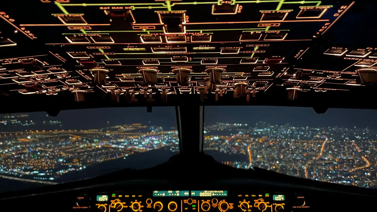 A backlit airplane cockpit instrument panel at night